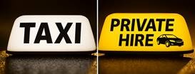 Yellow Taxi sign on top of a vehicle